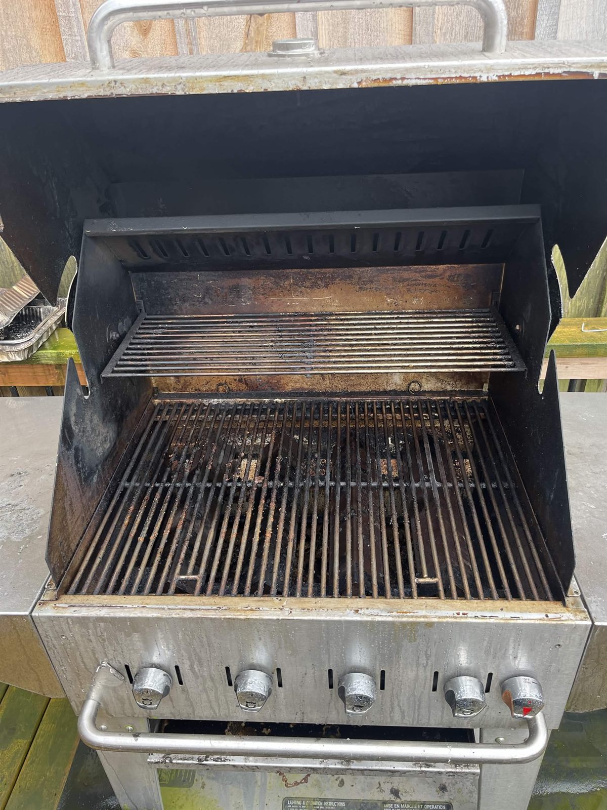 Grill caked with grease and char before cleaning